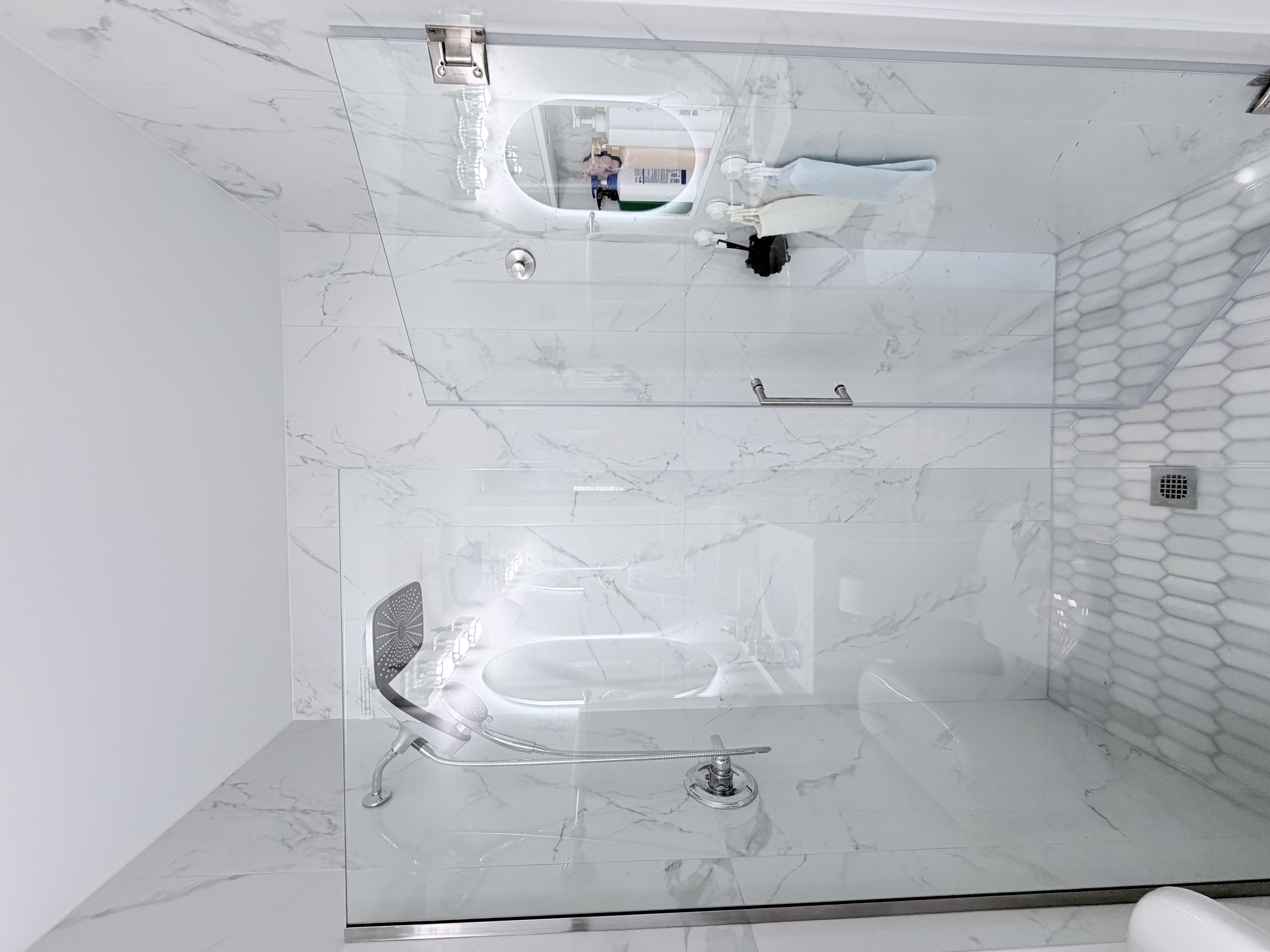Marble shower with glass enclosure